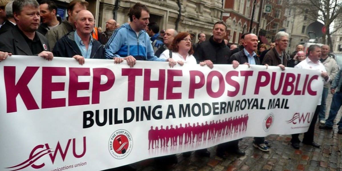 A group of men stand behind a banner that reads: Keep the post public