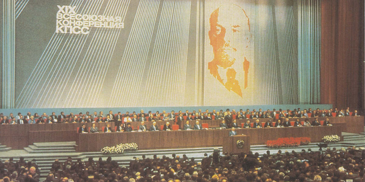 Delegates to the 19th congress of the Communist Party of the Soviet Union, seated before a stage in front of a large portrait of Vladimir Lenin