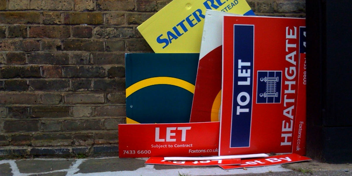 Several To Let signs piled together on the ground