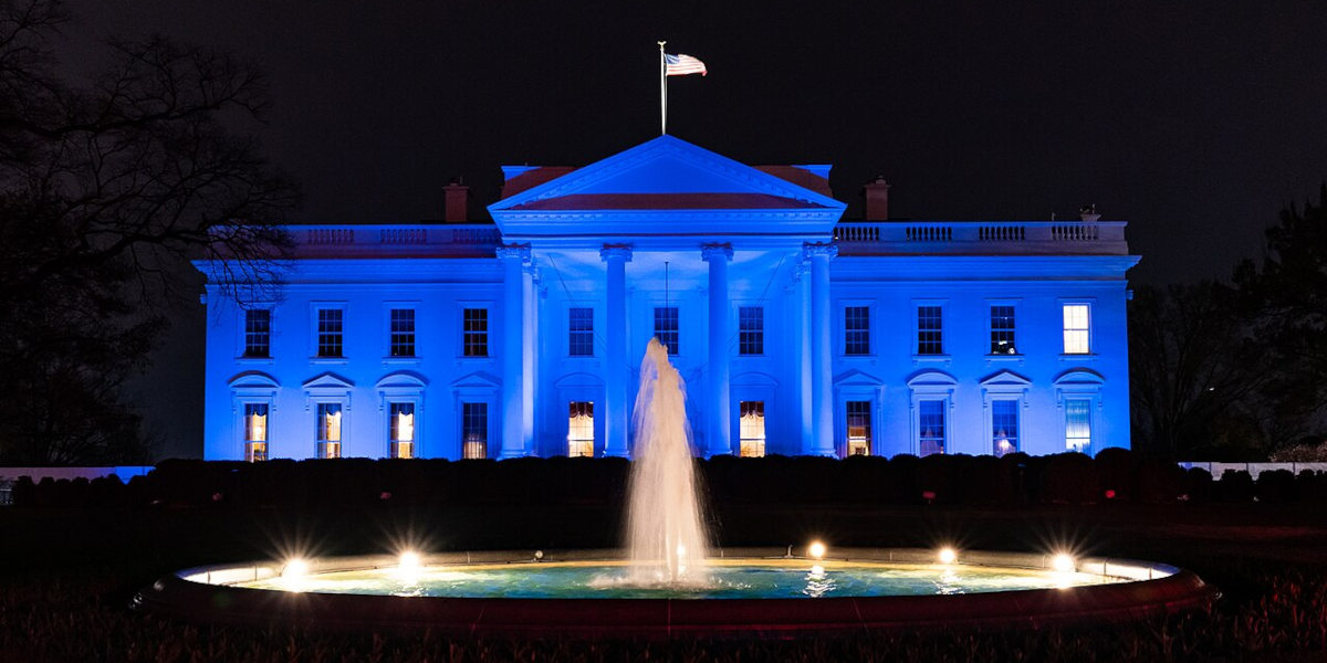 The White House in Washington DC at night, illuminated in blue for World Autism Awareness Day