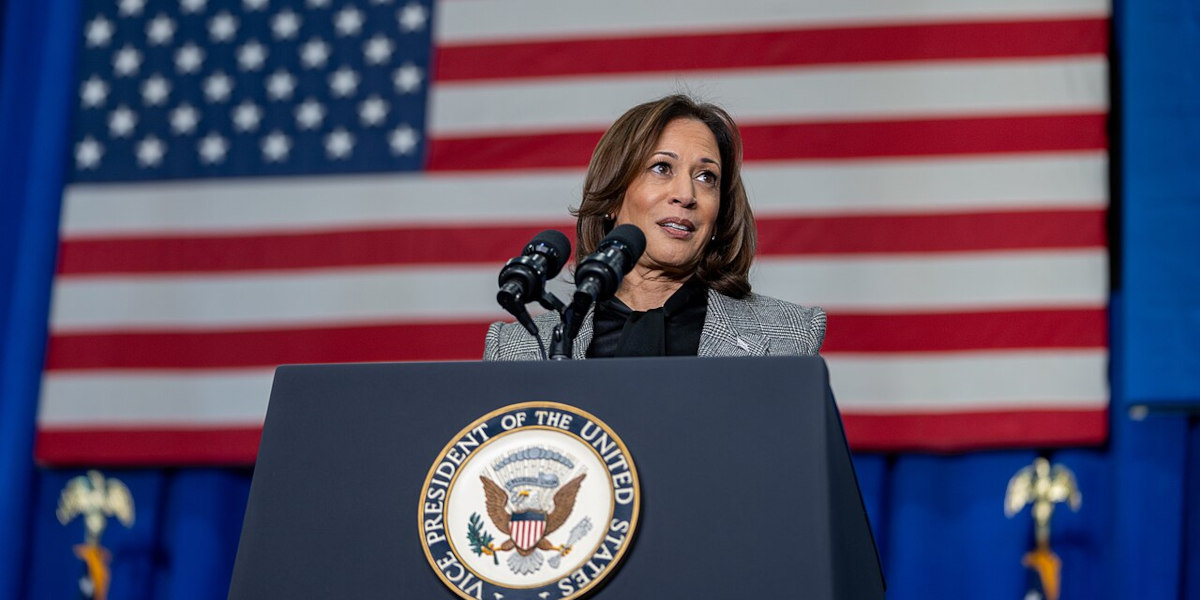 Former US Vice President Kamala Harris standing at a podium in front of the American flag